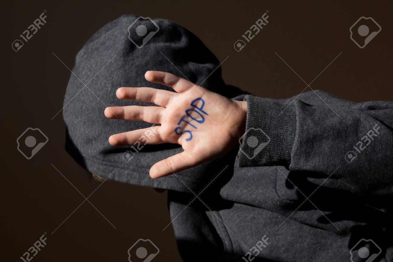 Abused teen with stop hand jesture