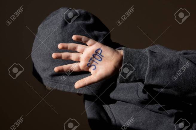 Abused teen with stop hand jesture